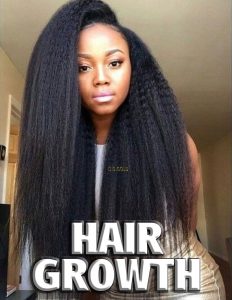African American black female young woman with long thick black hair wearing a gray fitted mini dress looking straight at the camera